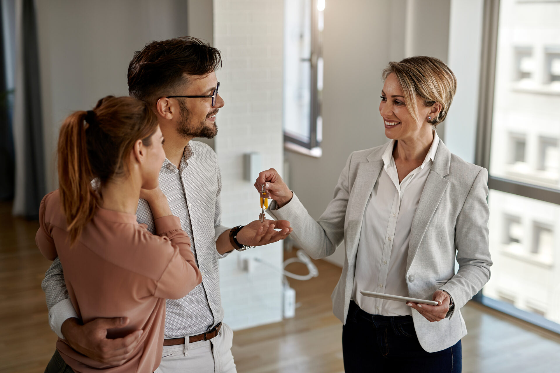 Real estate agent handing keys